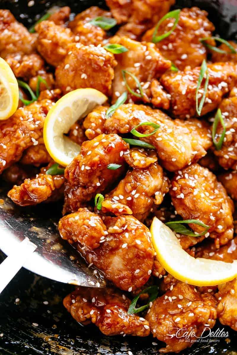 Chicken bites with a sticky, sweet and sour, Chinese lemon sauce, sprinkled with sesame seeds and sliced spring onion. 