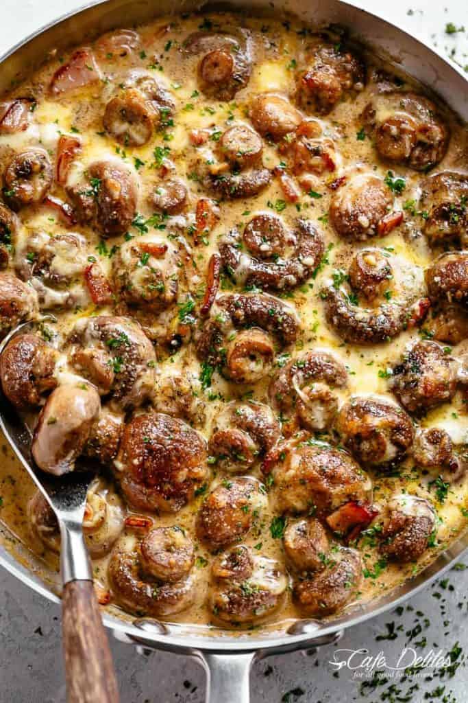Creamy Garlic Mushrooms and bacon in a mouthwatering cheesy sauce as a side or main. The best Low Carb or Keto Mushroom Recipe! | cafedelites.com