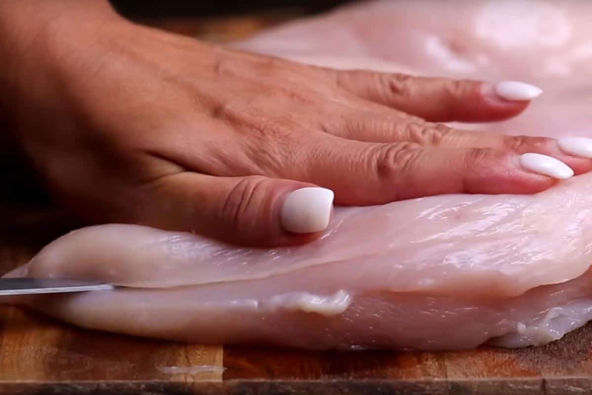 Slicing the chicken breast horizontally.