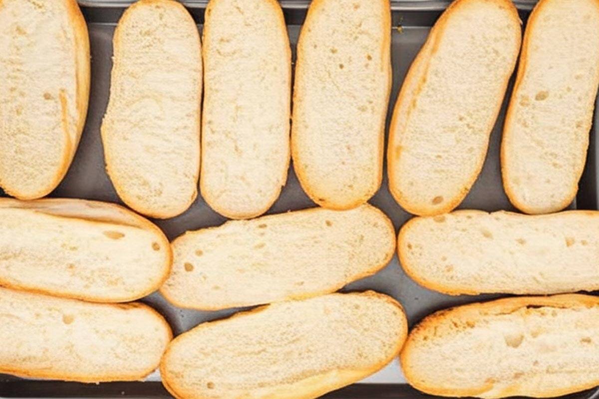 Hoagie rolls on a baking sheet.