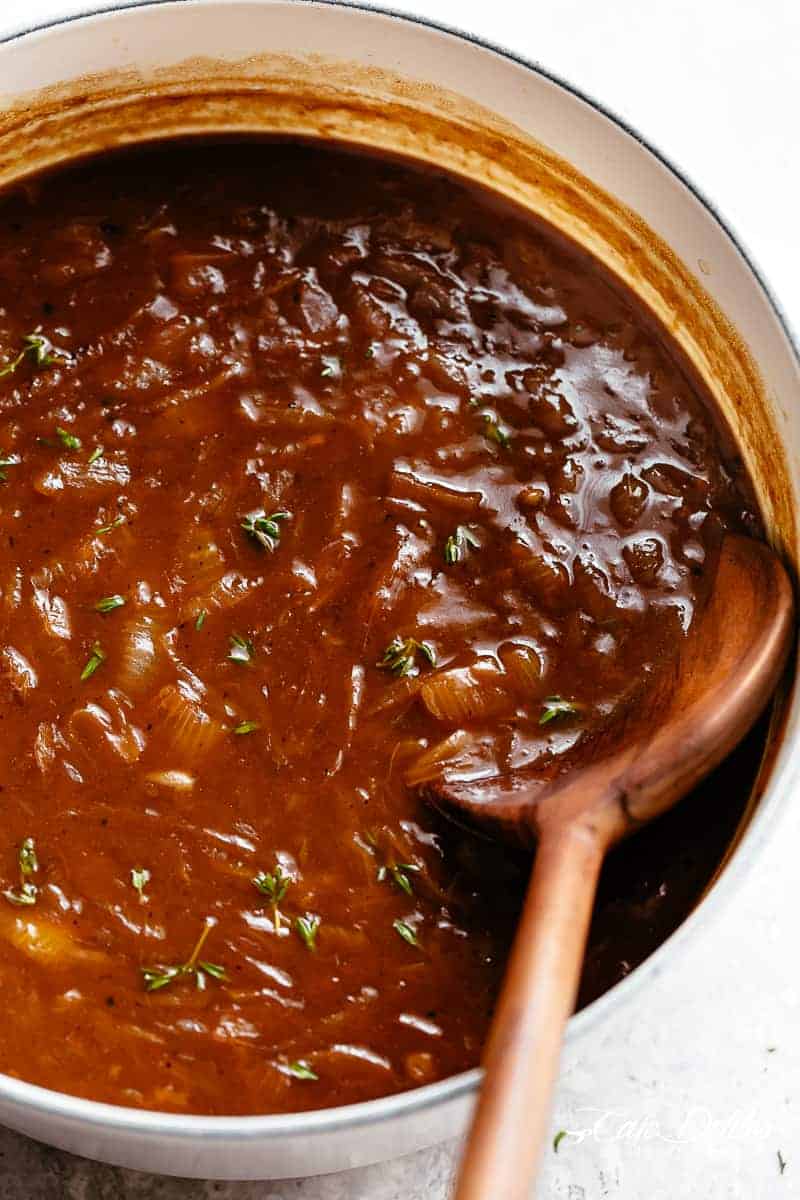 Classic French Onion Soup is one of the most delicious soups in the world! Caramelized onions create a stock filled with an intense depth of flavour. Simmered with fresh herbs, optional white wine and finished off with garlic bread slices topped with two types of melted cheese. | cafedelites.com