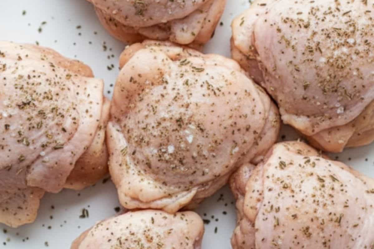 Pat the chicken thighs dry, then season them well with salt, pepper, and dried thyme.