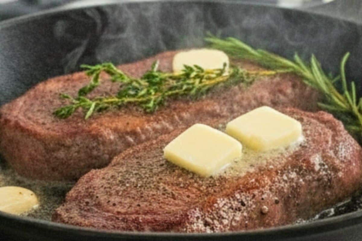 Add 2 tablespoons of butter, 3 crushed garlic cloves, and a few sprigs of thyme.