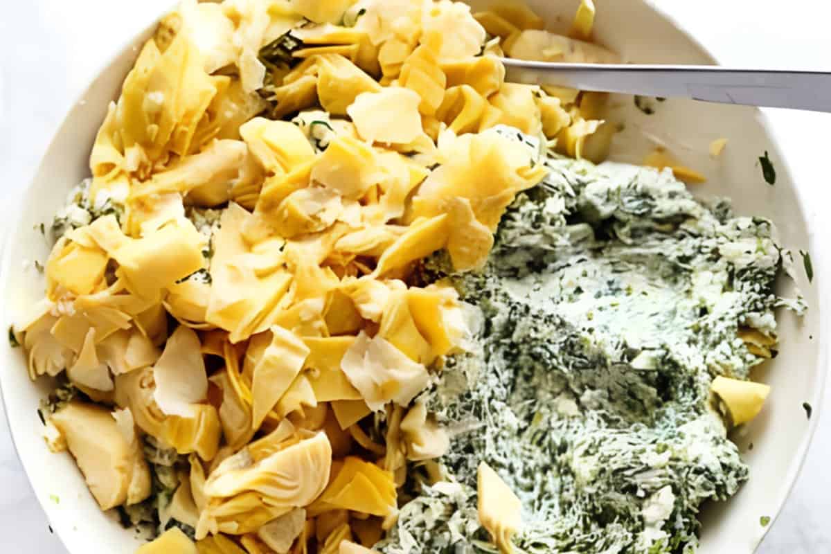 Spinach, cream cheese, chopped artichokes, mozzarella, parmesan, garlic,and pinch of salt mixed together  in a bowl, 