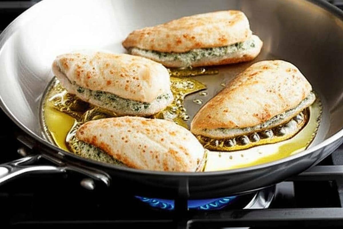 Searing the chicken in a large skillet.