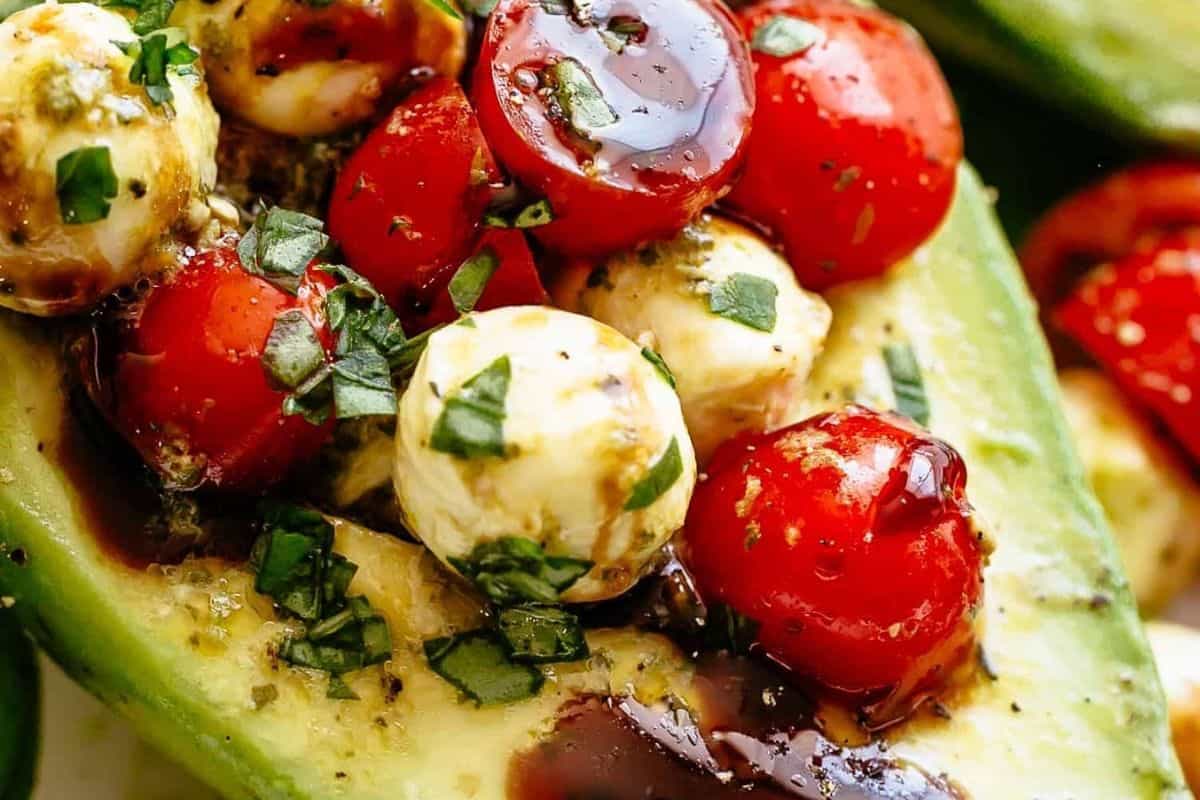 Arrange the avocado halves on a plate and spoon the caprese mixture into each avocados. Drizzle with balsamic glaze, sprinkle with chopped basil.