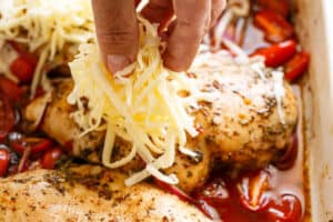 Adding cheese to the chicken before baking