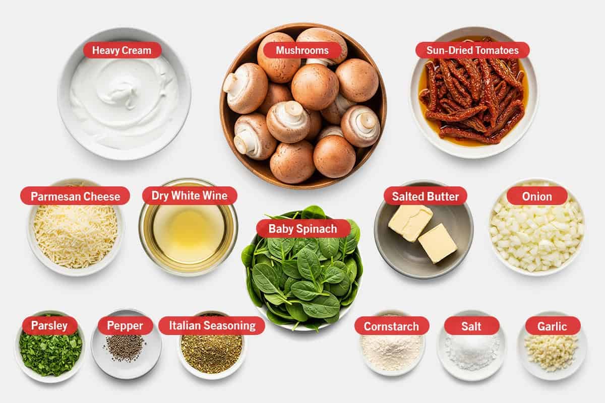Top shot of ingredients: Heavy cream, mushrooms, sun-dried tomatoes, parmesan cheese, dry white wine, baby spinach, unsalted butter, onion, parsley, pepper, Italian seasoning, cornstarch, salt, and garlic.