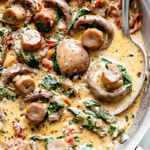 Creamy Garlic Butter Tuscan Mushrooms in a bowl and spoon