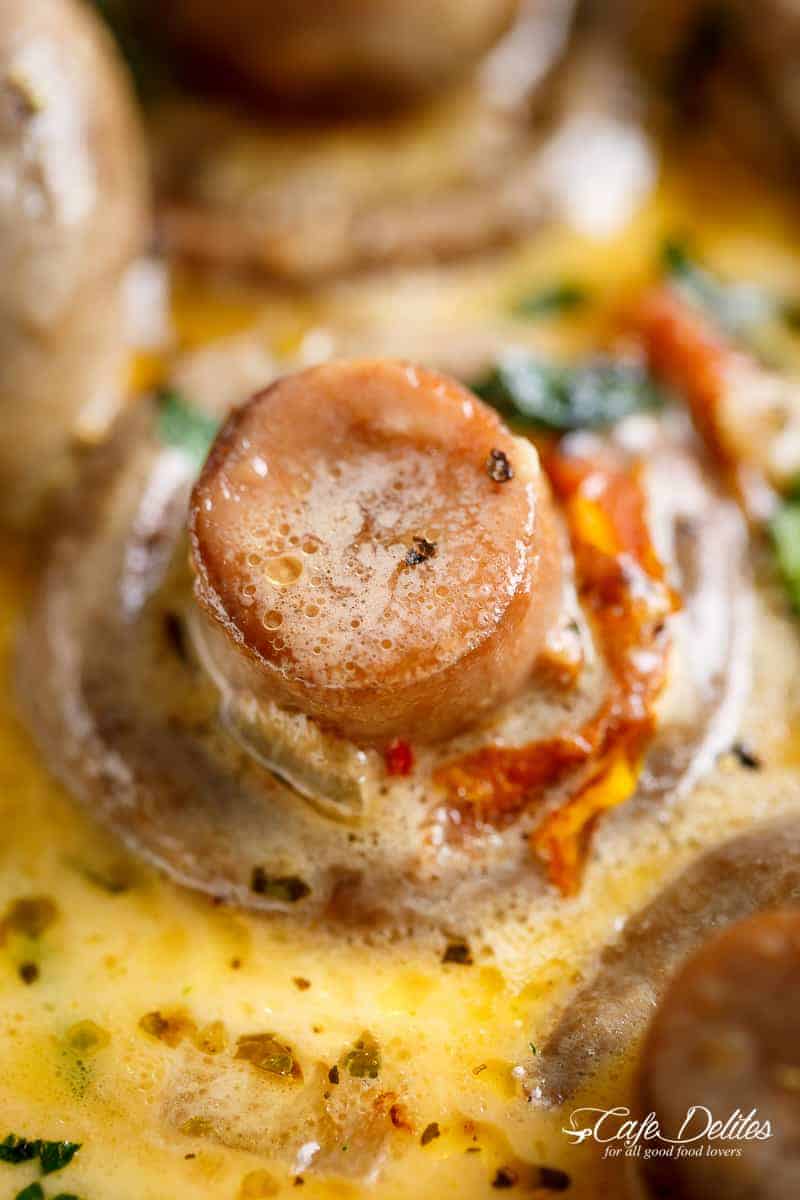 Creamy Garlic Butter Tuscan Mushrooms in a rich sauce filled with garlic, sun dried tomatoes, parmesan cheese and spinach. KETO and LOW CARB! | cafedelites.com