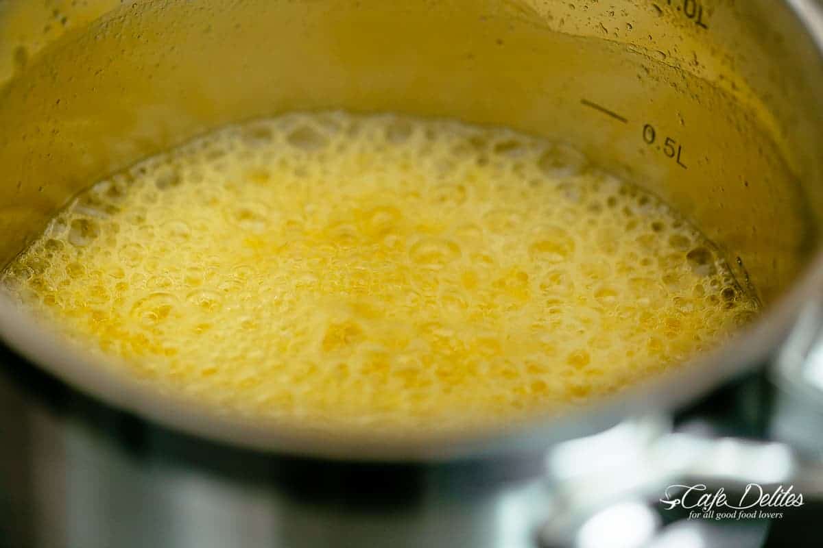 Foaming golden butter in a silver pot.