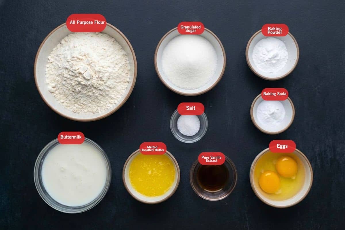 Flat lay photo of ingredient shot of all purpose flour, granulated sugar, baking powder, baking soda, soda, eggs, pure vanilla extract, melted unsalted butter, buttermilk