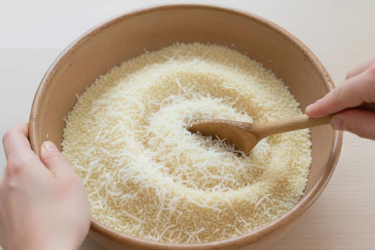 Breadcrumbs with freshly grated parmesan cheese in a bowl.