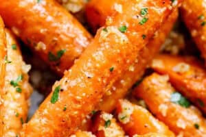 Freshly made garlic parmesan roasted carrots topped with parsley and ready to serve