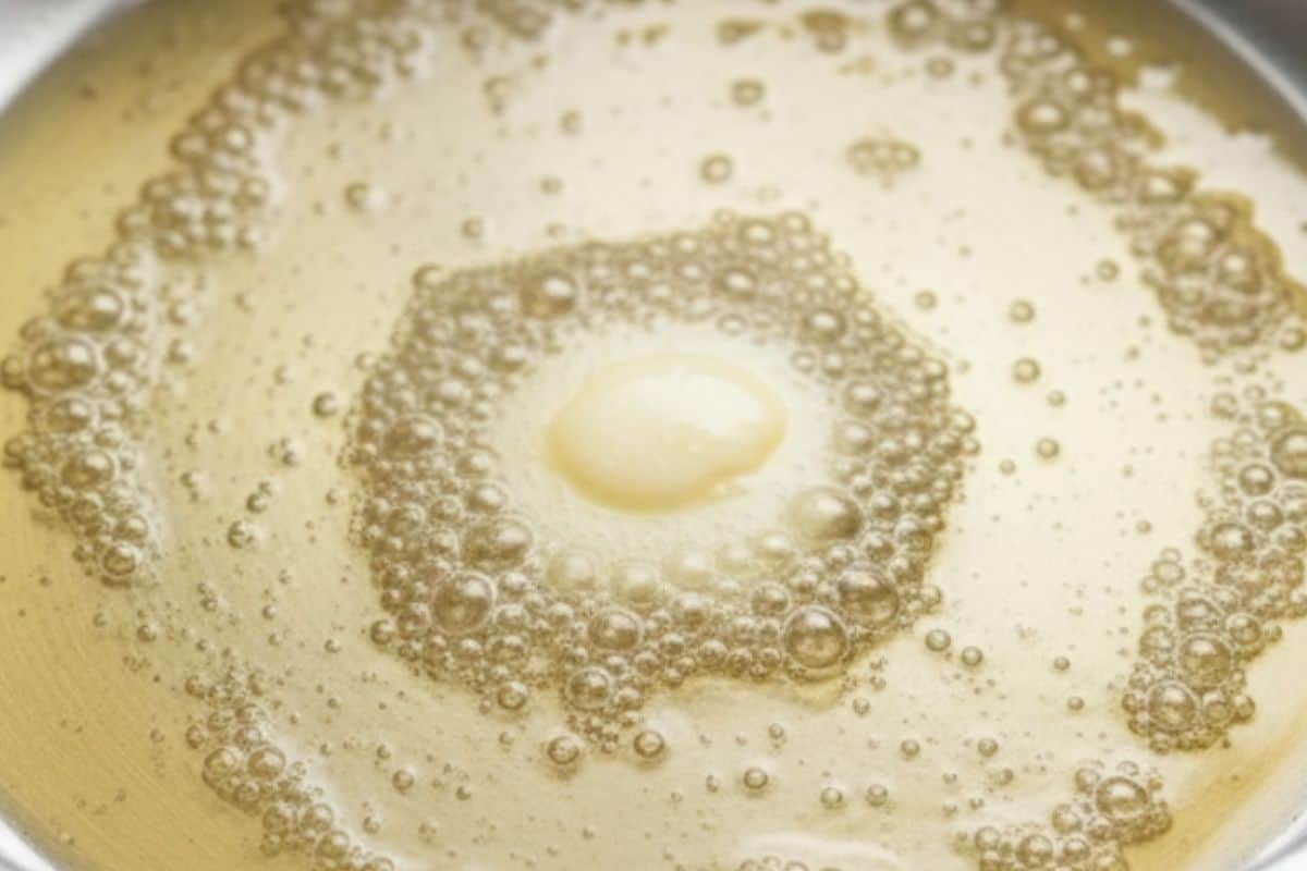 Warm oil and butter in a large skillet.