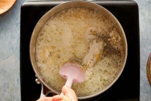 Flour being added to butter to make roux for gravy