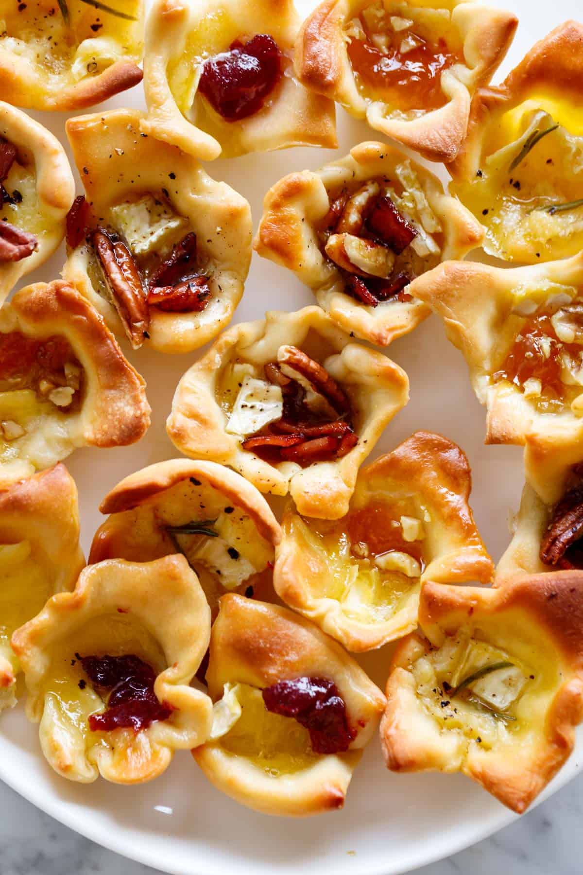 A plate full of the baked brie bites.