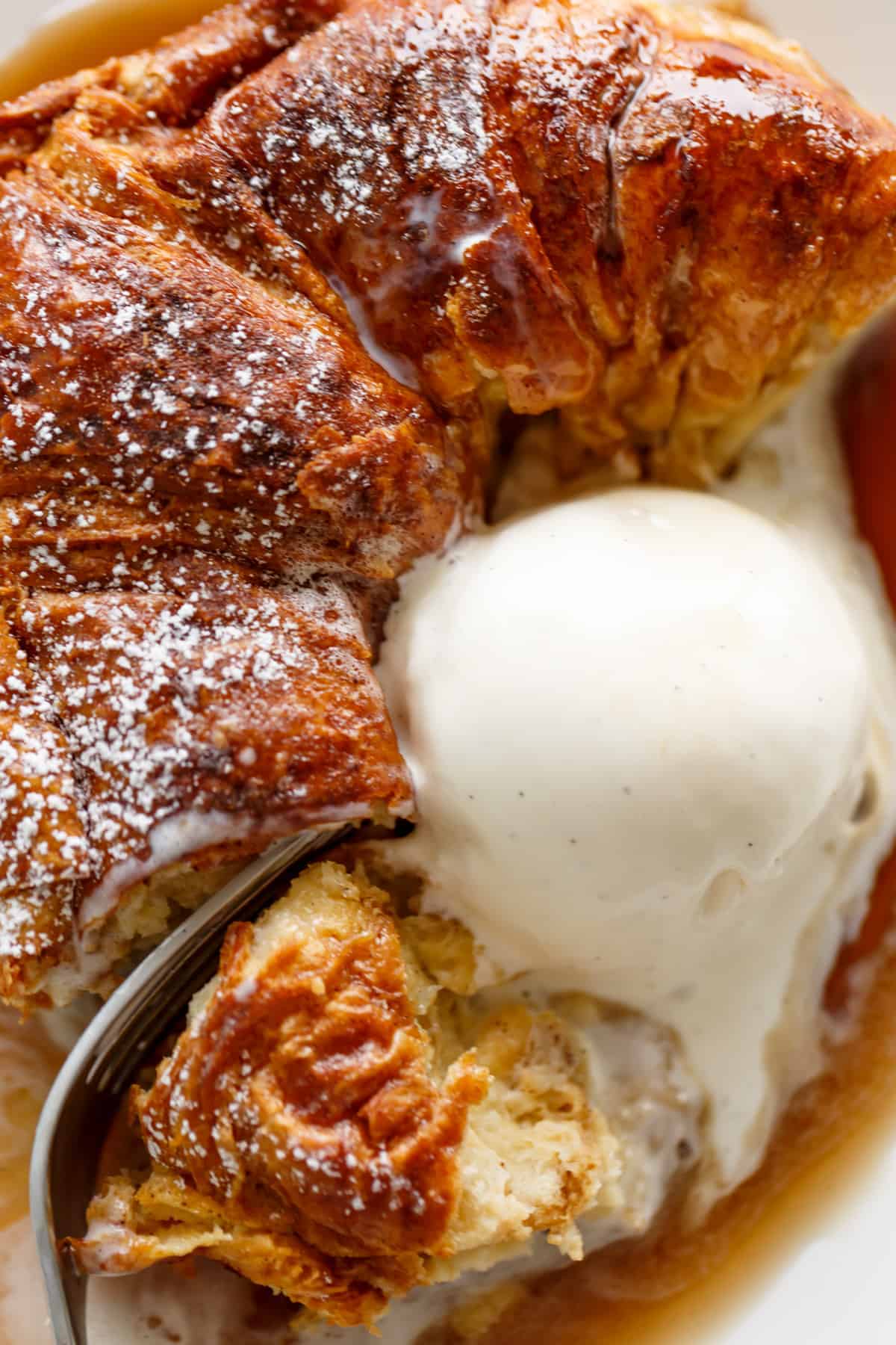 Croissant French Toast on a plate with ice cream | cafedelites.com