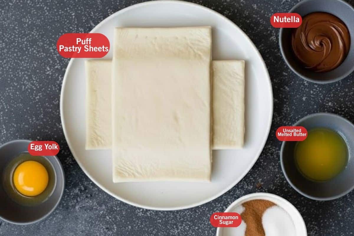 Flat lay photo of ingredient shot of puff pastry sheets, Nutella, egg yolk, unsalted melted butter, cinnamon mixed white sugar