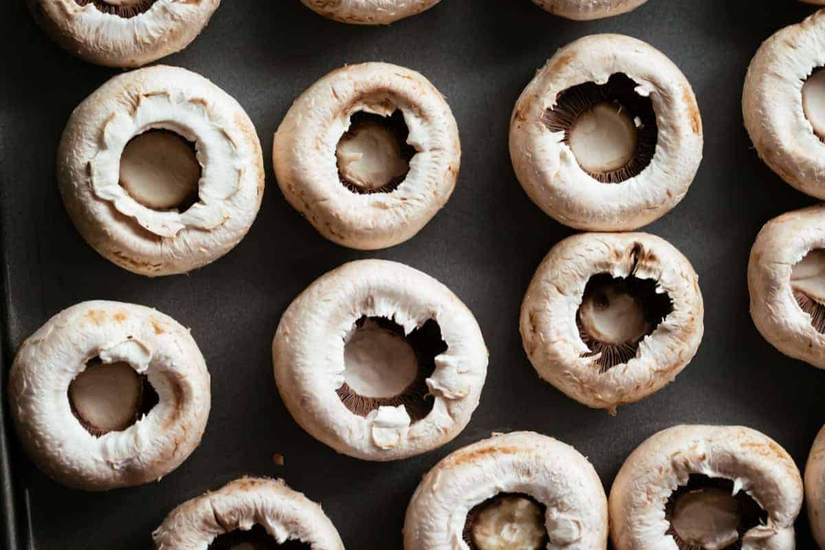 Hollowed caps on a baking tray. 