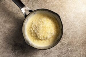 Parmesan cheese added to the milk, butter, and flour