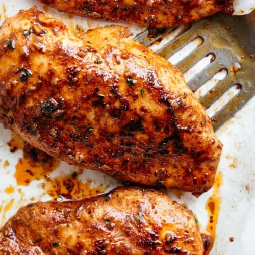 A fork pierced in Oven Baked Chicken Breast piece