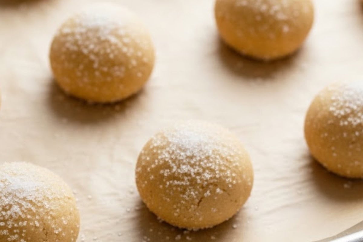 Roll 1½ tablespoons of dough into balls, coat each one in sugar, and arrange them 2 inches apart on the baking sheet.