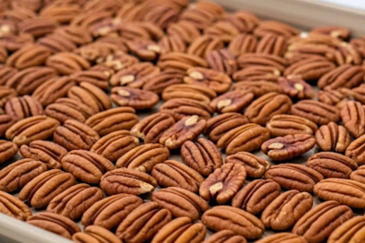 Spread the pecans on a baking sheet and toast for 6 minutes in the oven.