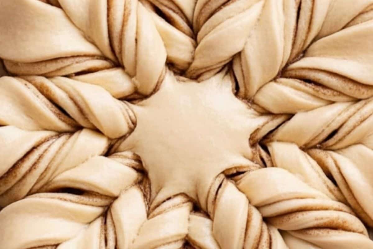 Lightly mark a center ring with a small cup, cut into 16 strips, twist pairs away twice, and pinch tips to form a star.