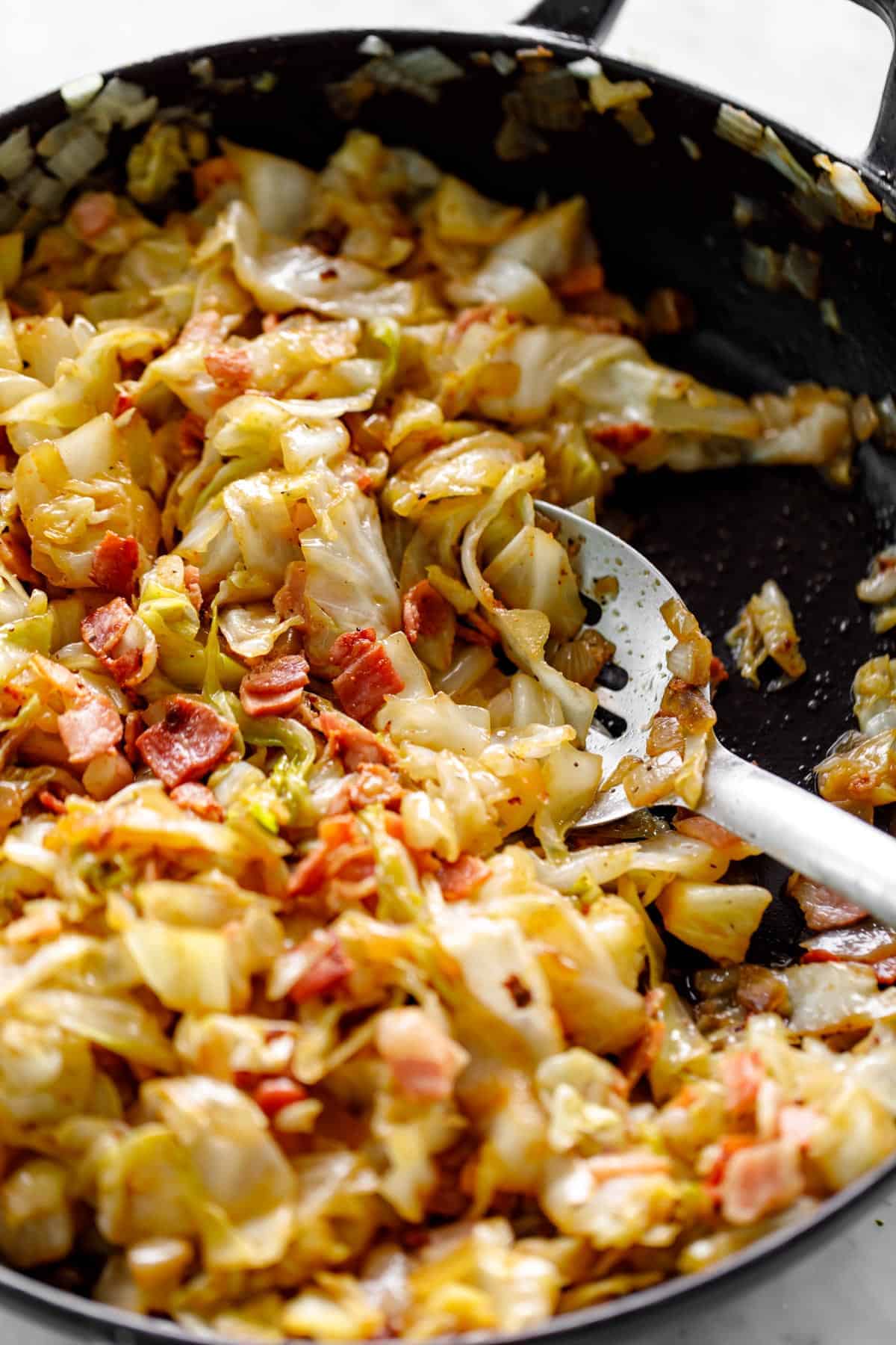 Fried cabbage in a skillet.