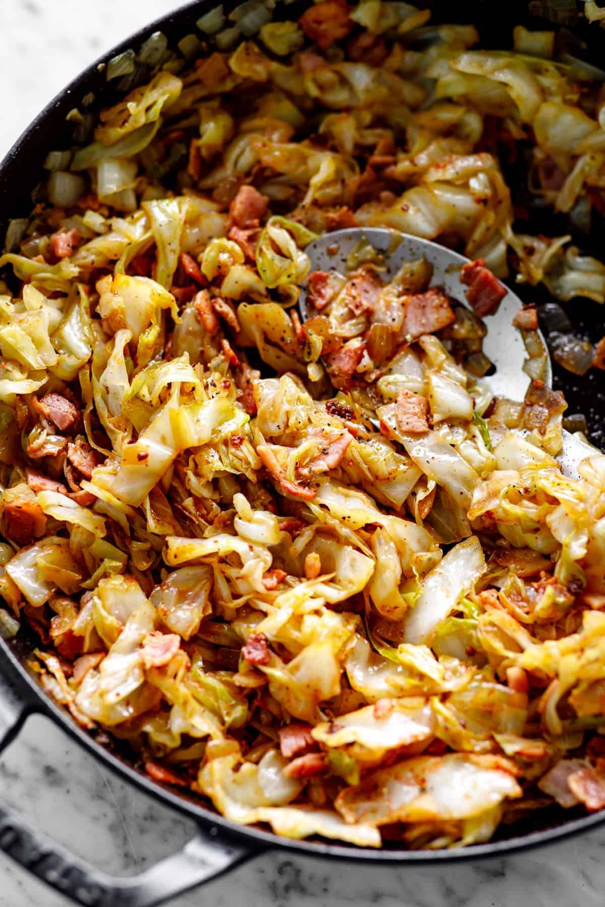 Fried Cabbage with bacon in a Staub cast-iron skillet | cafedelites.com