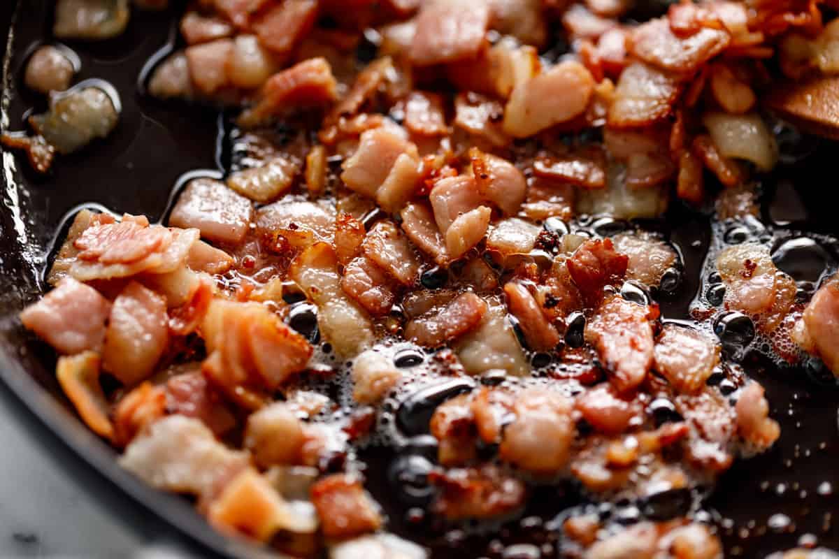 Bacon cooking in a skillet.