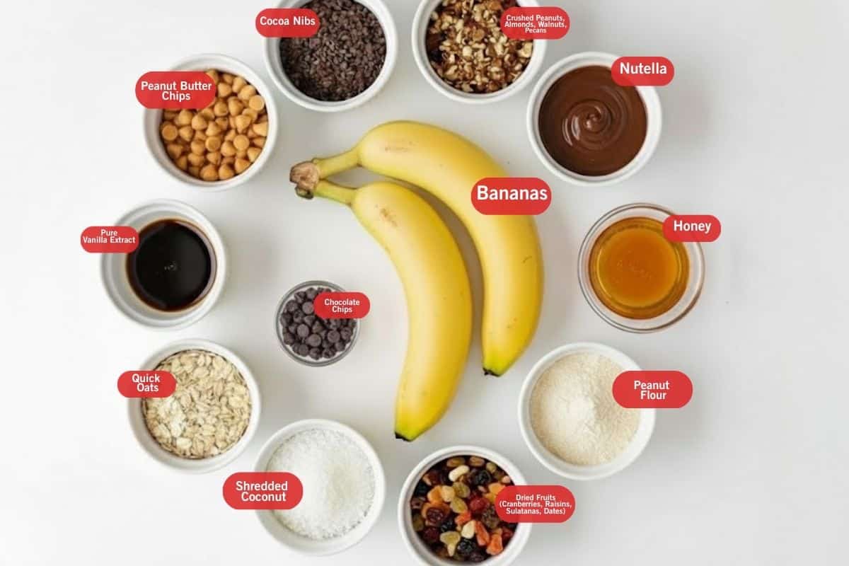 Flat lay photo of ingredient shot of peanut butter chips, cocoa nibs, crushed peanuts, pecans, almonds and walnuts, dried fruit ( cranberries, raisins, sultanas, chopped dates), bananas, peanut flour, shredded coconut, quick oats, pure vanilla extract, chocolate chips