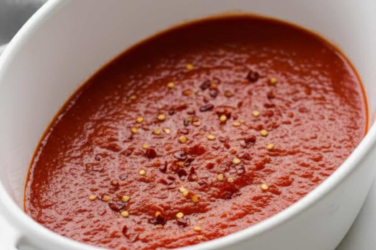 Marinara in a basking dish, sprinkled with chili flakes.