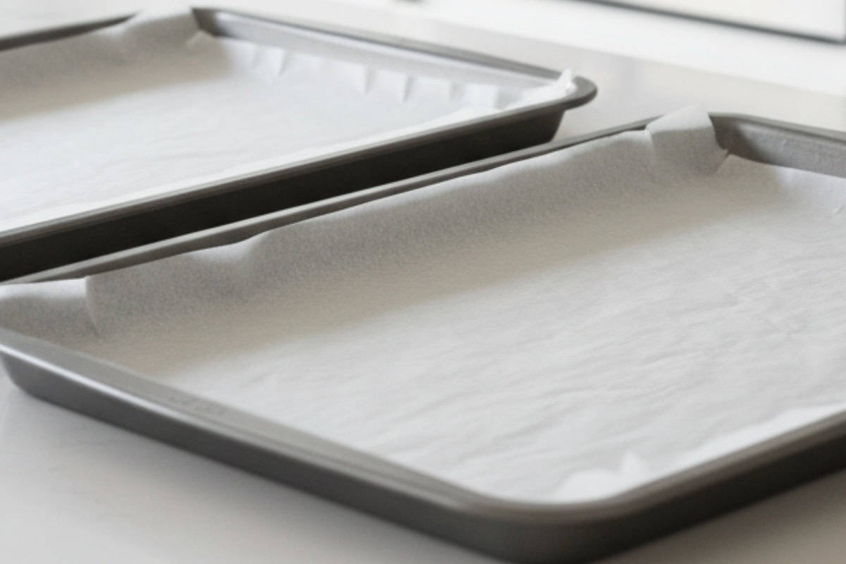 Line two large baking sheets with parchment and preheat oven.