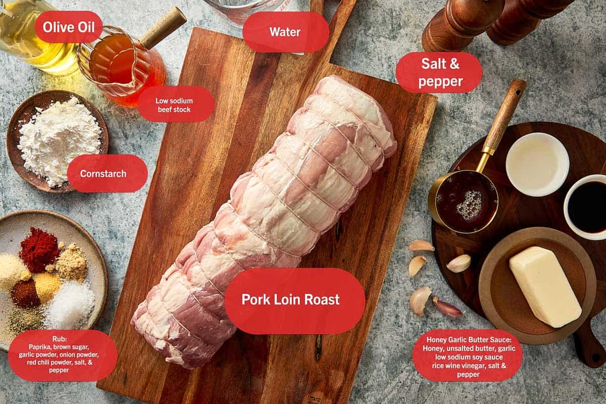 a list of ingredients to with the pork loin in the middle resting on a wooden board, the rest of the ingredients are in bowls