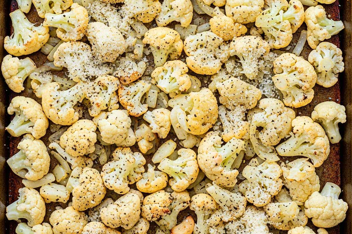 Cauliflower sprinkled with freshly grated parmesan cheese.