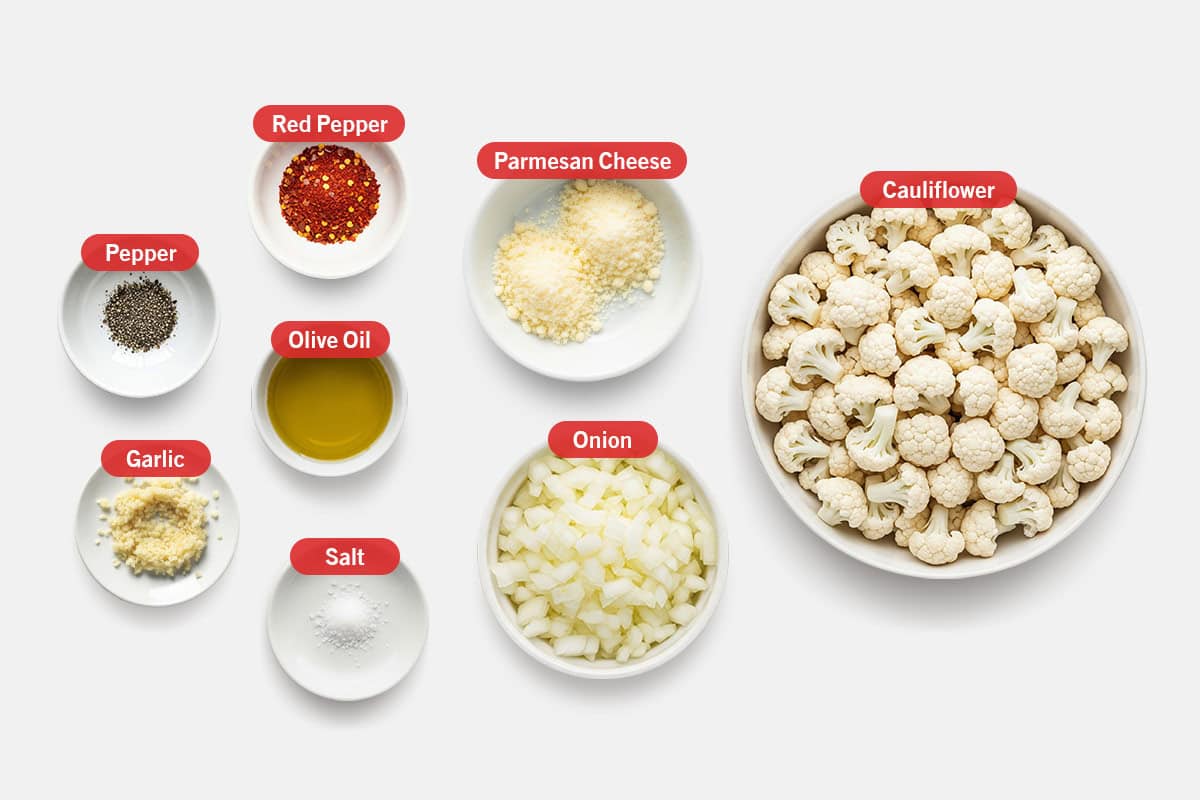 Top shot of ingredients: Cauliflower, onion, garlic, olive oil, parmesan cheese, red pepper, pepper, salt.