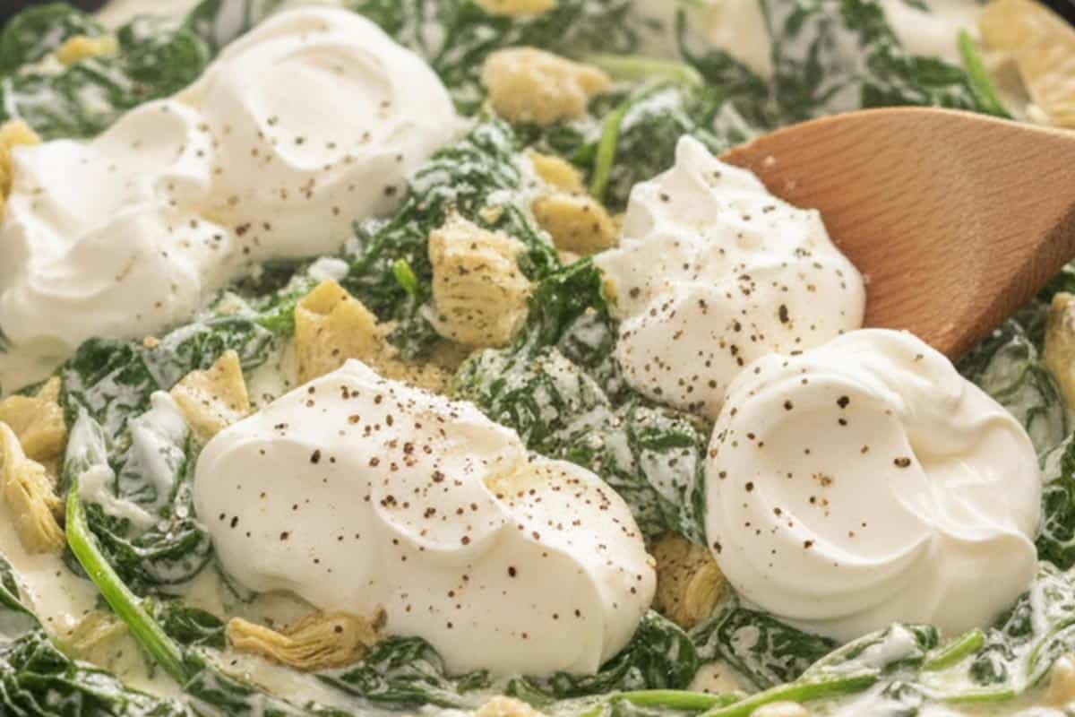 Stirred in the spinach, artichokes, cream cheese, sour cream, yogurt, milk, and a pinch each of salt and pepper.
