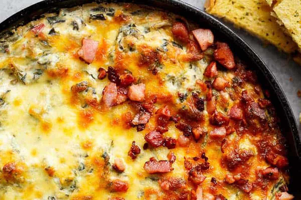 Close-up shot of Spinach Artichoke Dip with Bacon.