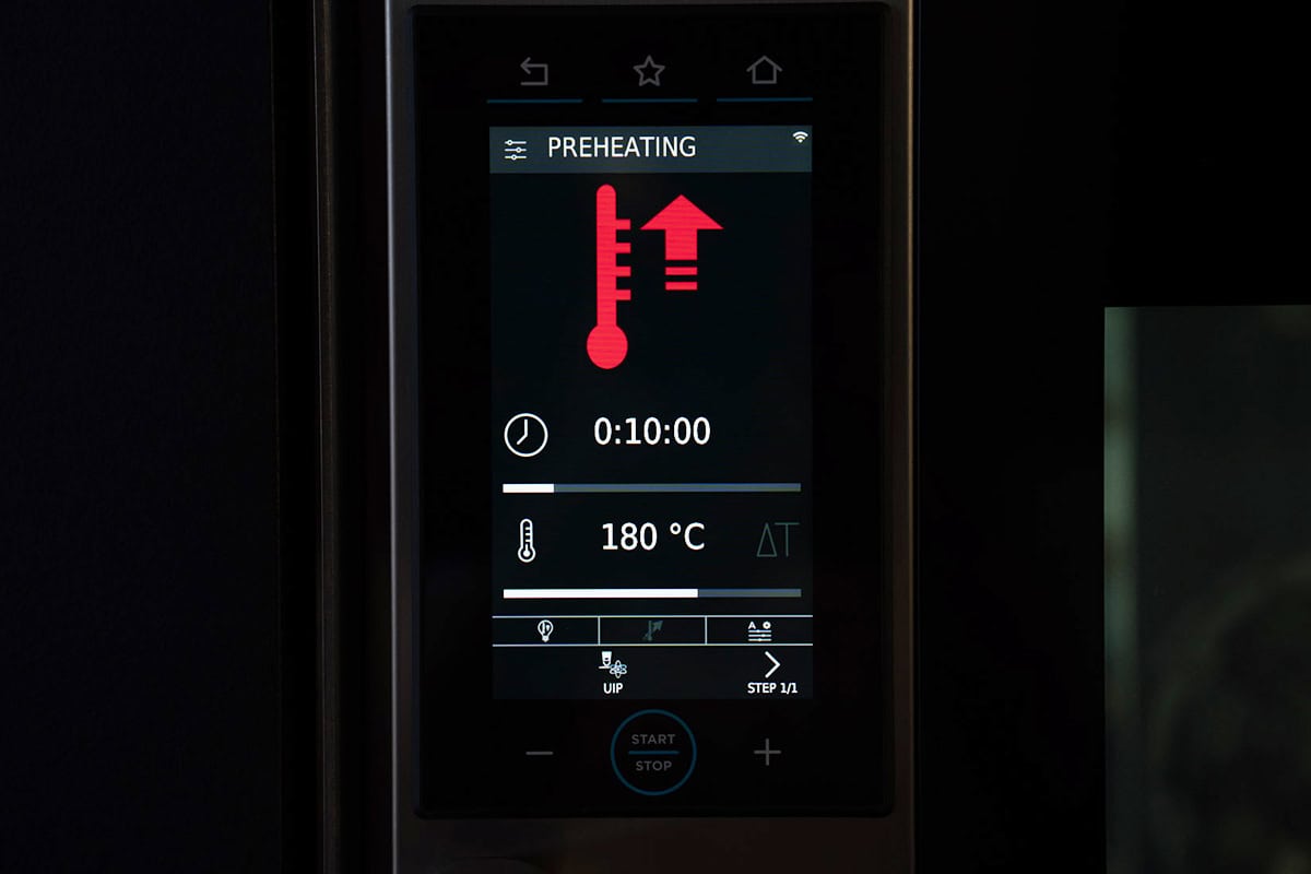 Image showing the oven preheating to 180°C.
