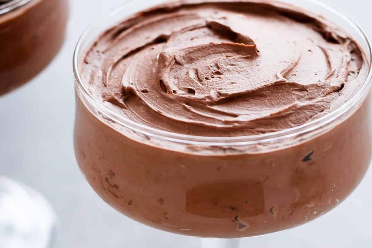 Portion the mousse into cups and chill until set. Top with reserved whipped cream and with chocolate shavings.