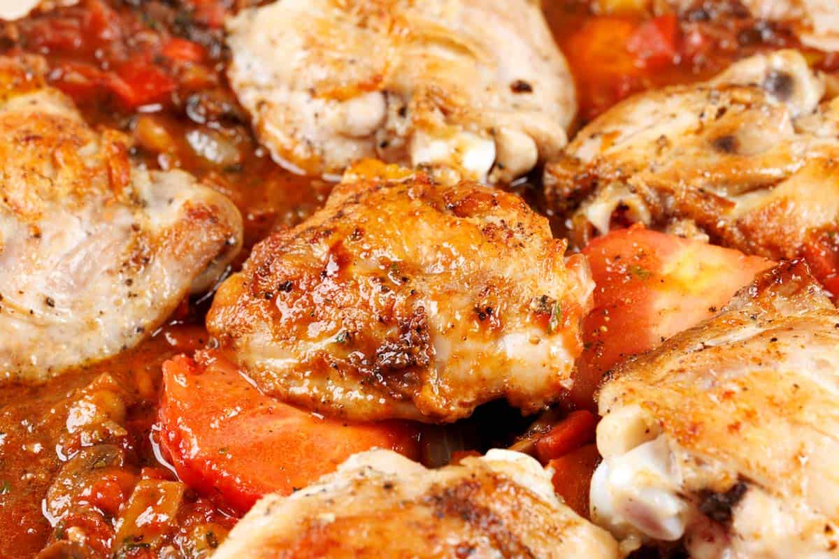 chicken simmering in sauce