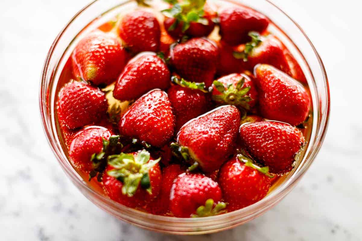 A bowl of strawberries soaking in alcohol | cafedelites.com