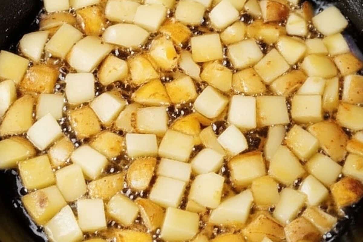 Fry the potatoes until golden and crispy in a cast iron skillet.