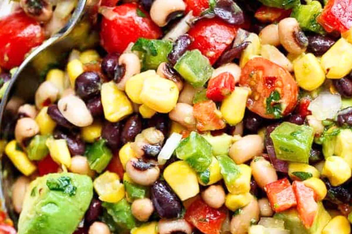 Add black eyed peas, black beans, corn, bell peppers, red onion, tomatoes, avocado, and cilantro to a large bowl; toss gently to combine.