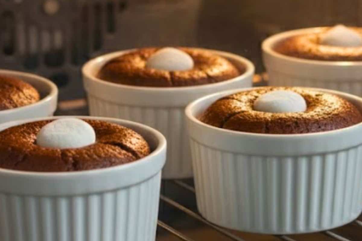 Pour batter into prepared molds, then press one marshmallow into the center of each.