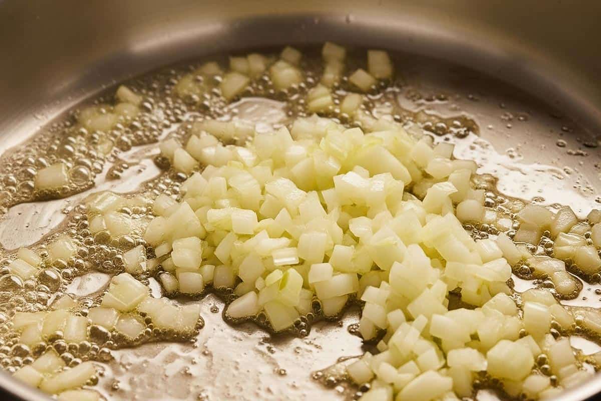 Cooking the onion with butter in a pan.