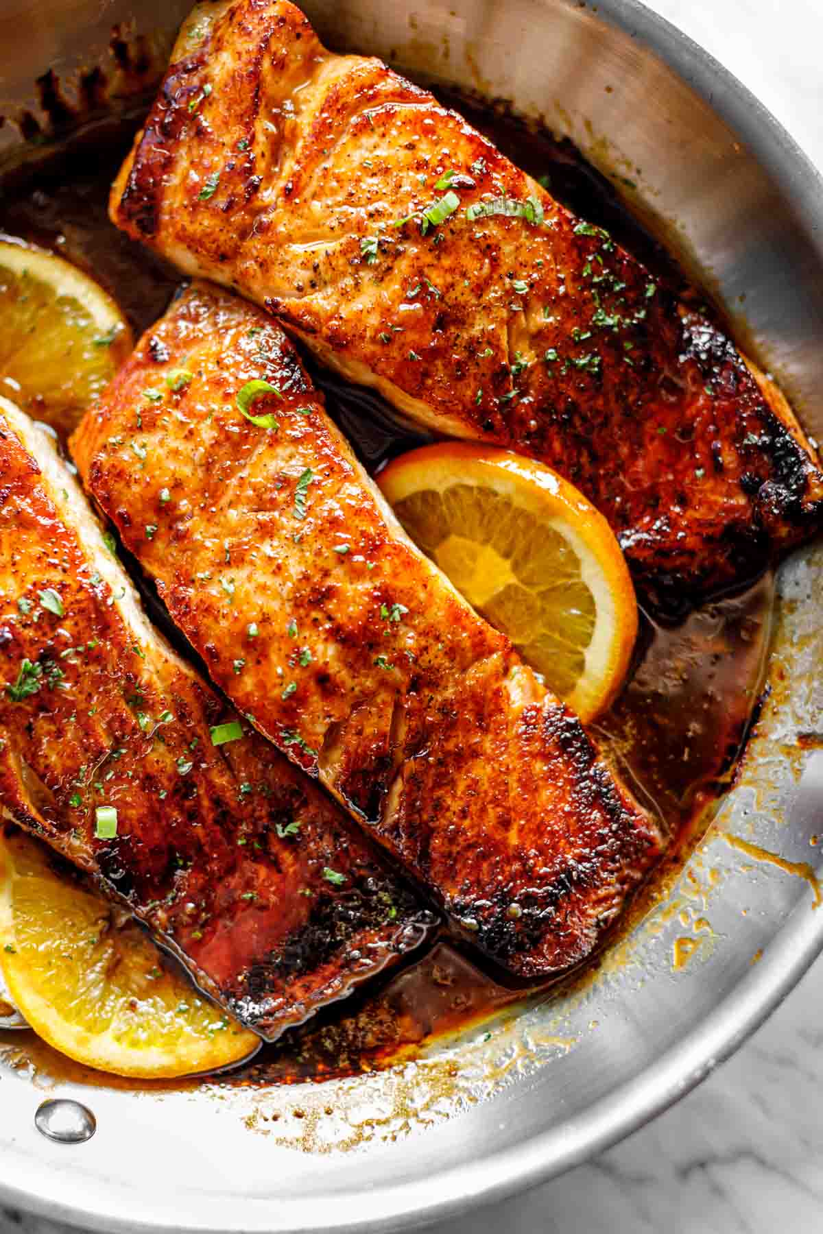 Crispy Honey Orange Glazed Salmon fillets are pan-fried in the most beautiful honey-orange-garlic sauce, with a splash of soy for added flavour! | cafedelites.com