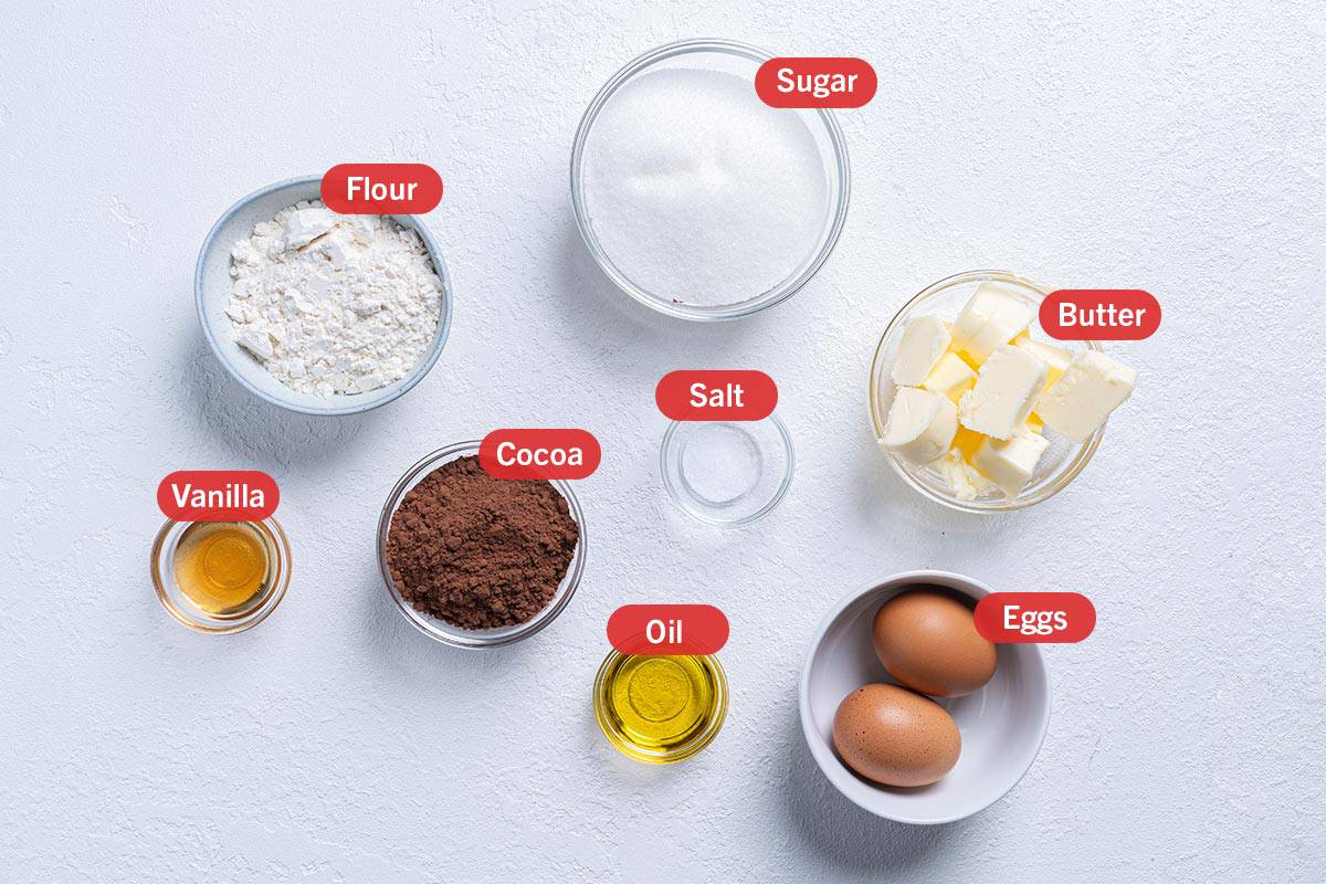 Image of the ingredients needed for the preparation of the Fudgy Cocoa Brownies, specifically: Butter, Flour, Sugar, Vanilla, Cocoa, Salt, Oil, and Eggs